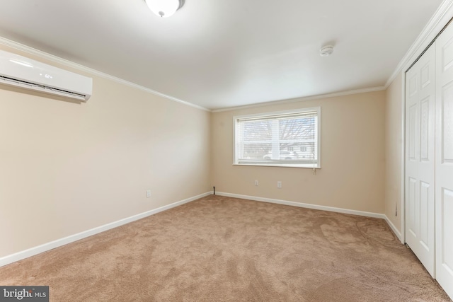 unfurnished bedroom featuring a wall unit AC, a closet, light colored carpet, and ornamental molding