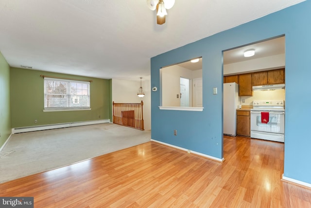 unfurnished living room with ceiling fan, baseboard heating, and light hardwood / wood-style flooring