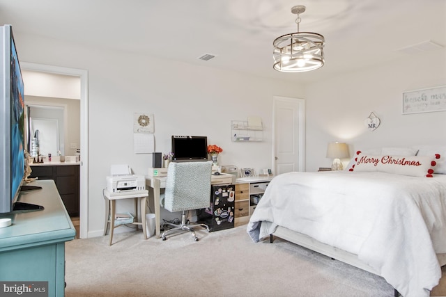 carpeted bedroom featuring an inviting chandelier