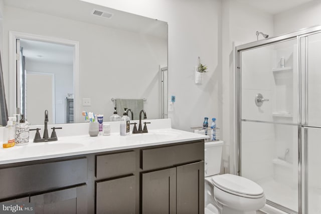 bathroom featuring vanity, toilet, and walk in shower