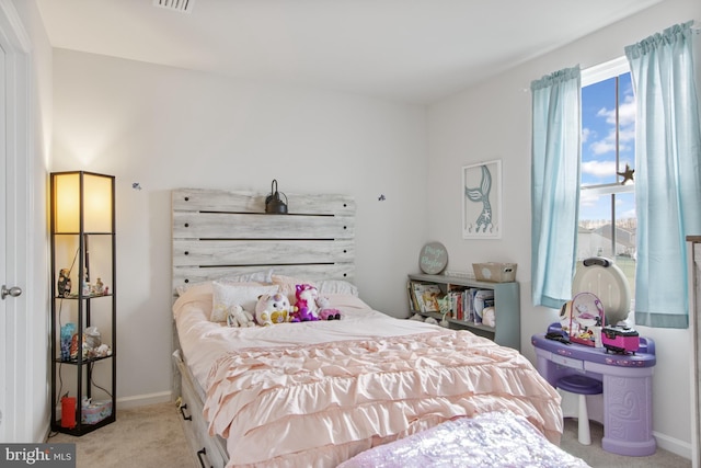 carpeted bedroom with multiple windows