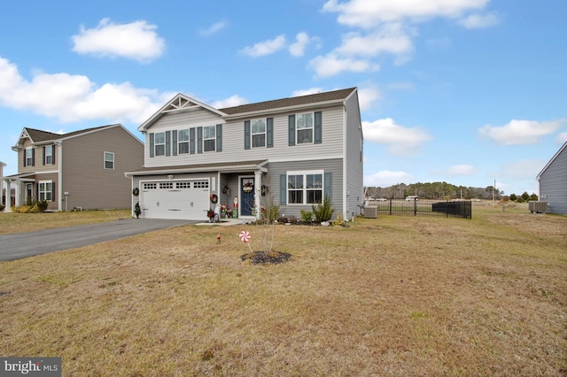 view of front of house with a front lawn, central AC unit, and a garage