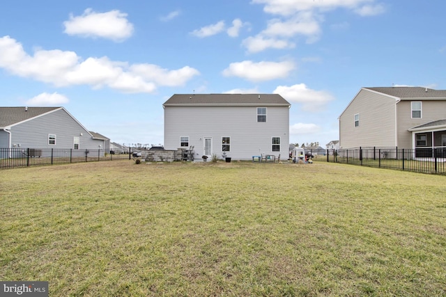 back of house featuring a lawn