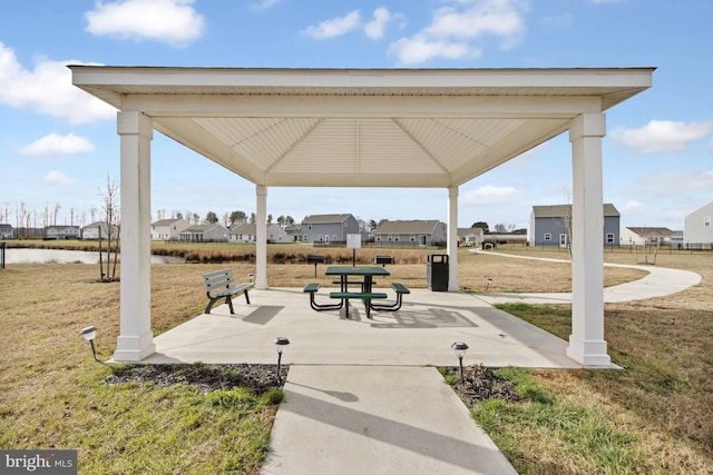 view of property's community featuring a gazebo, a lawn, and a water view