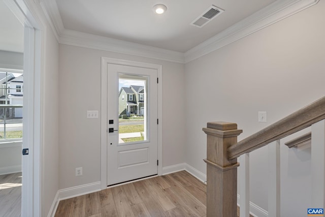 foyer entrance featuring light hardwood / wood-style floors and ornamental molding