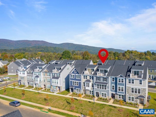 birds eye view of property with a mountain view