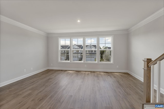 unfurnished living room featuring crown molding and wood-type flooring