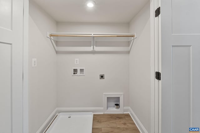 laundry room with hookup for an electric dryer, light hardwood / wood-style floors, and washer hookup