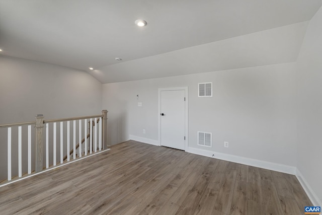 bonus room featuring light hardwood / wood-style floors and lofted ceiling