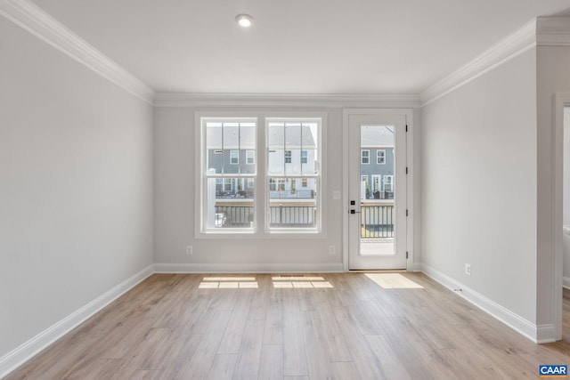 unfurnished room with crown molding and light wood-type flooring