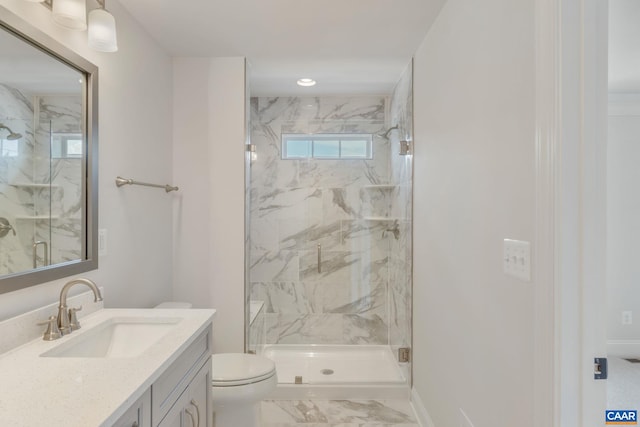 bathroom featuring vanity, toilet, and a shower with door