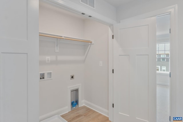 washroom featuring electric dryer hookup, light hardwood / wood-style flooring, and washer hookup