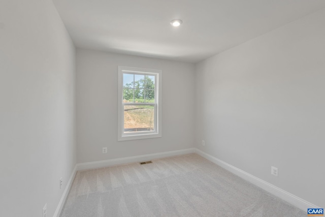 unfurnished room with light colored carpet