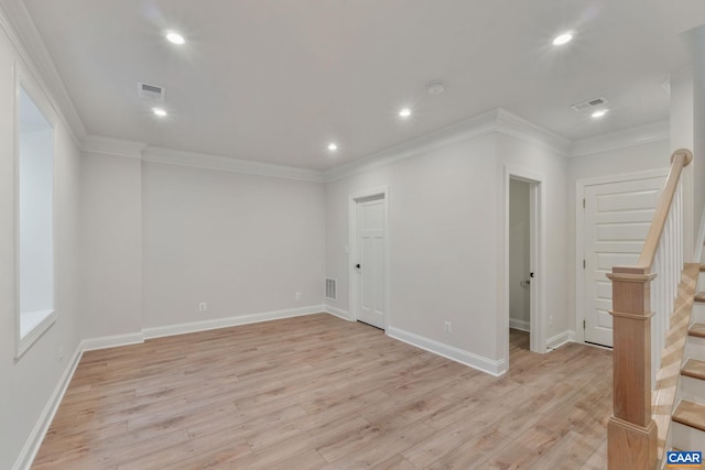 unfurnished room with crown molding and light hardwood / wood-style floors