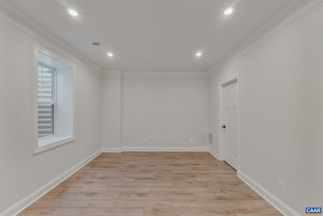 unfurnished room featuring ornamental molding and light hardwood / wood-style flooring