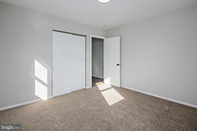 unfurnished bedroom featuring carpet floors and a closet