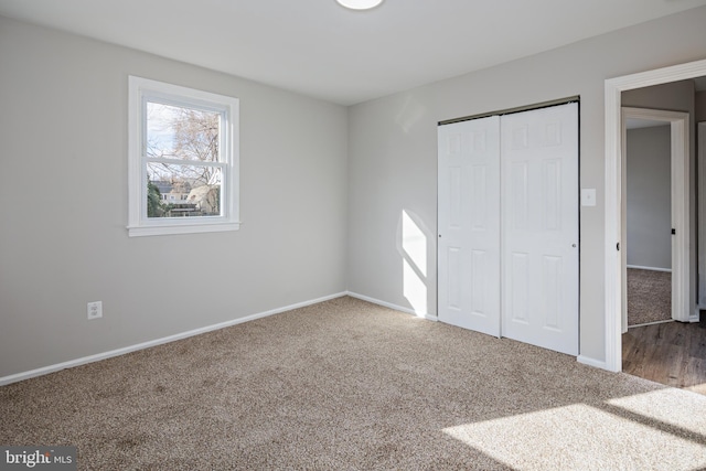 unfurnished bedroom with a closet and carpet