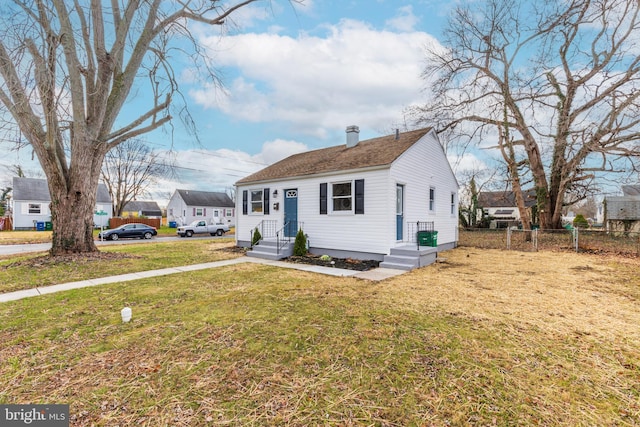 bungalow-style house with a front lawn