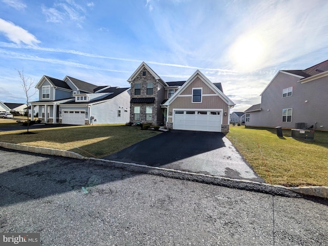 view of front facade with cooling unit, a garage, and a front yard