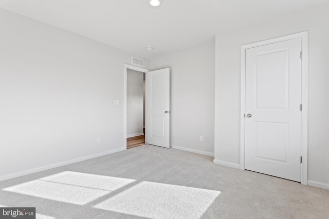 unfurnished bedroom with light colored carpet