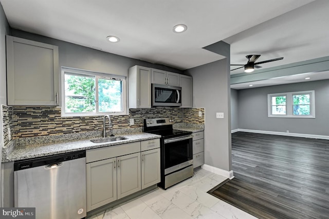 kitchen featuring gray cabinets, sink, plenty of natural light, and appliances with stainless steel finishes