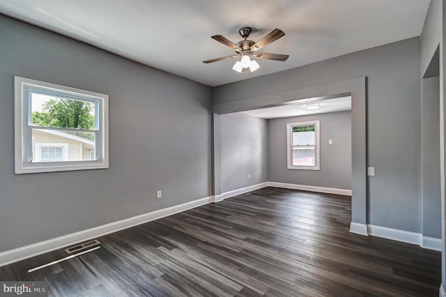 unfurnished room with ceiling fan, plenty of natural light, and dark hardwood / wood-style floors