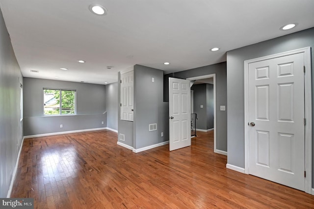 spare room with wood-type flooring