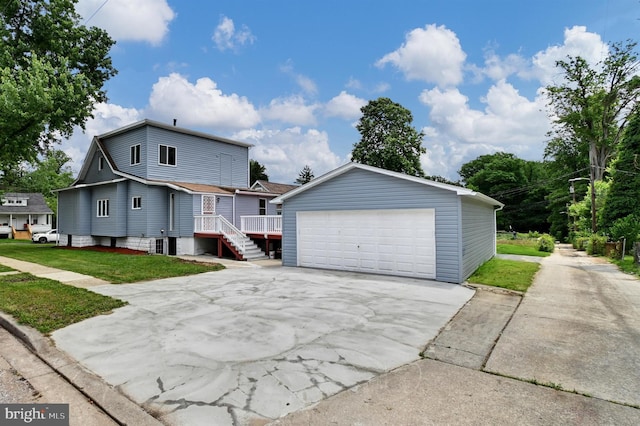 view of front of house featuring a wooden deck, a front yard, and a garage