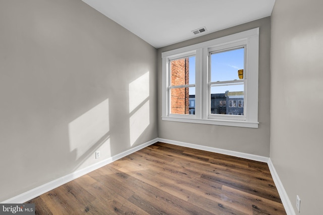 empty room with dark wood-type flooring