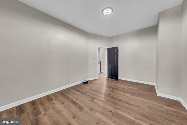 empty room with hardwood / wood-style flooring