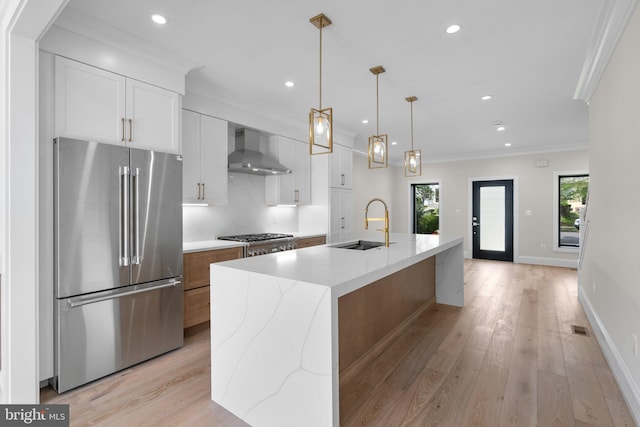 3710 S St NW, Washington, DC 20007 - kitchen featuring white cabinets, stainless steel appliances, wall chimney range hood, ornamental molding, and a sink