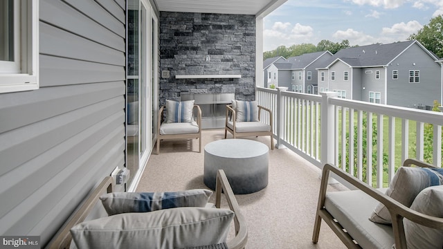 balcony featuring a fireplace