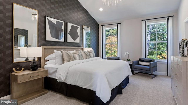 carpeted bedroom with vaulted ceiling and multiple windows