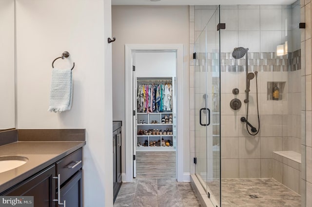 bathroom with vanity and a shower with shower door