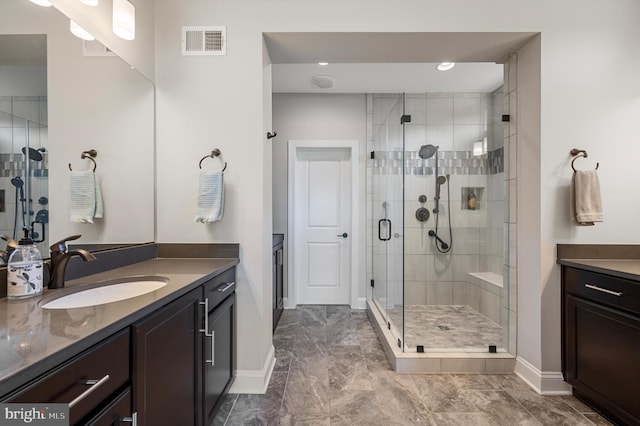 bathroom featuring vanity and a shower with door