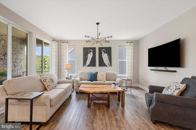 living room featuring hardwood / wood-style floors and an inviting chandelier