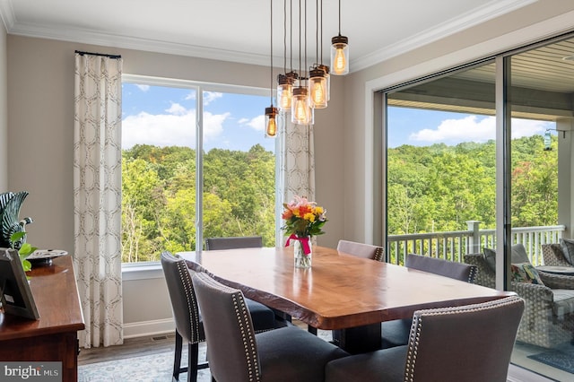 dining room featuring crown molding and hardwood / wood-style floors