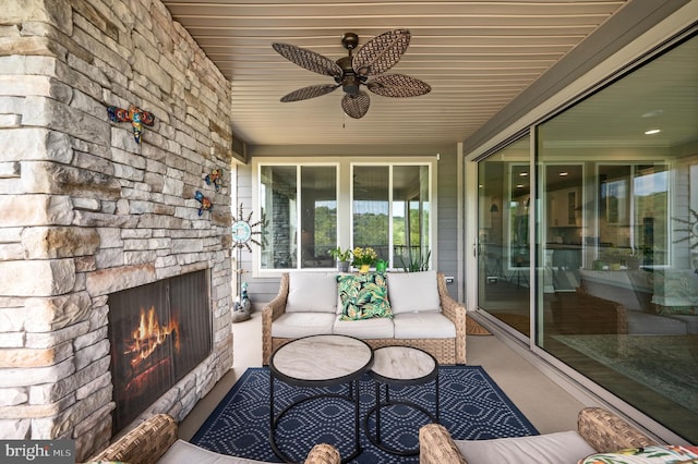 view of patio / terrace featuring an outdoor living space with a fireplace and ceiling fan