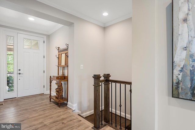 entrance foyer with light hardwood / wood-style floors and ornamental molding