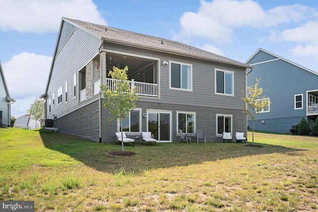 rear view of property with a lawn