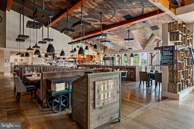 kitchen featuring beamed ceiling, wood-type flooring, wood ceiling, and high vaulted ceiling