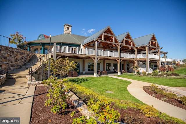 rear view of house with a lawn, a patio area, and outdoor lounge area