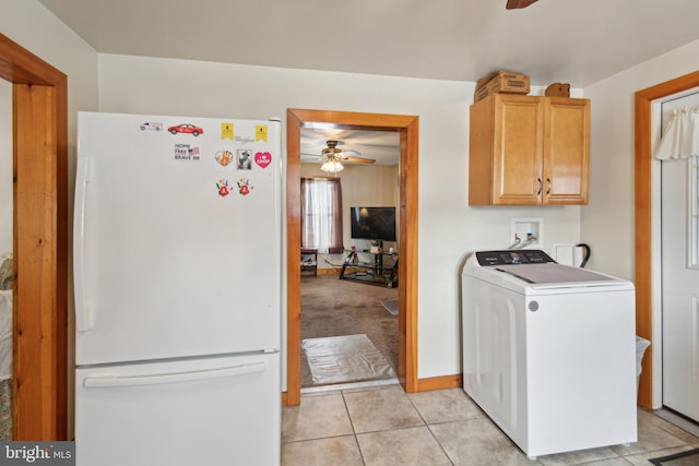 washroom with ceiling fan, cabinets, washer / clothes dryer, and light tile patterned floors