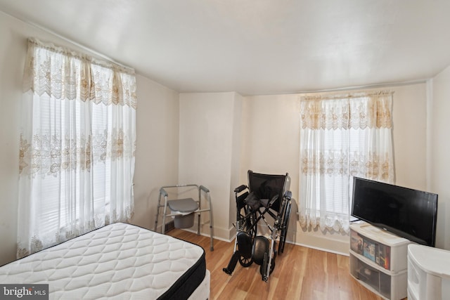 bedroom with hardwood / wood-style floors