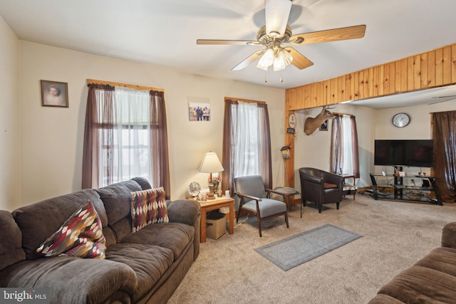 living room with light carpet and ceiling fan