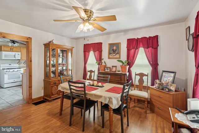 dining room with ceiling fan and light hardwood / wood-style floors