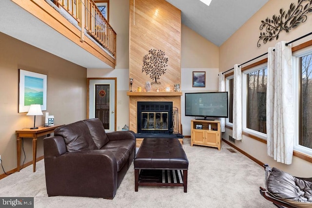 living room with light carpet, high vaulted ceiling, and a tiled fireplace