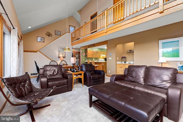 living room with carpet and high vaulted ceiling