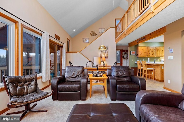 living room featuring light carpet and high vaulted ceiling