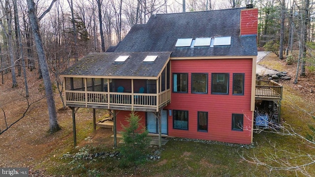 back of house with a sunroom